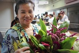 A woman holding a bunch of flowers and smiling