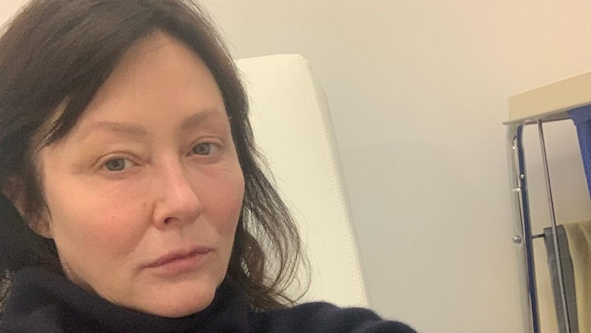 Shannen Doherty actress taking a selfie in a medical room