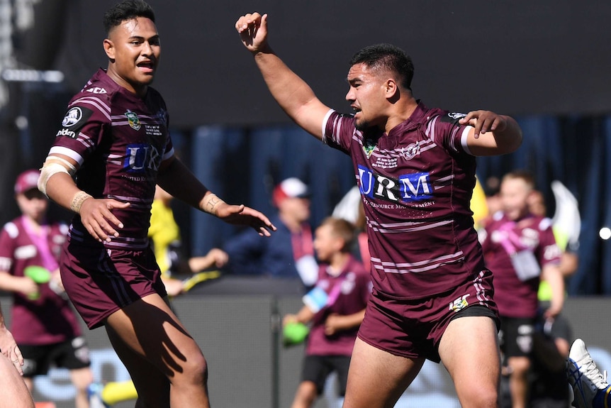 A Manly Sea Eagles under 20 players celebrates scoring a try in 2017.