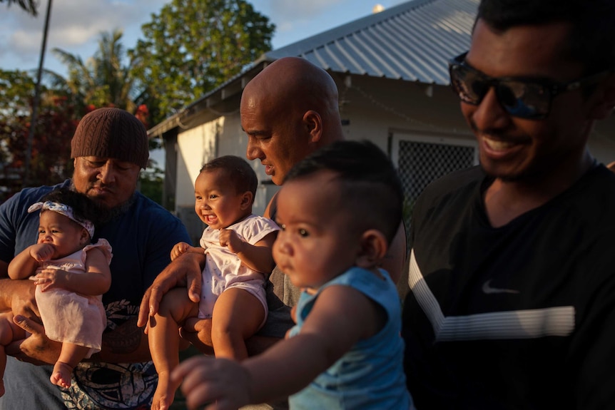 A group of fathers with their babies on Christmas Island.