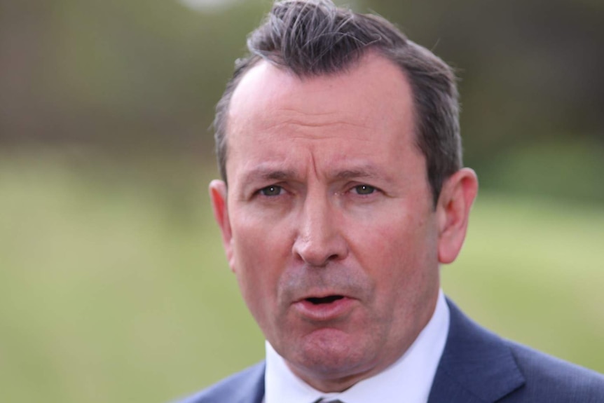 A close up of Mark McGowan wearing a blue suit and white shirt.
