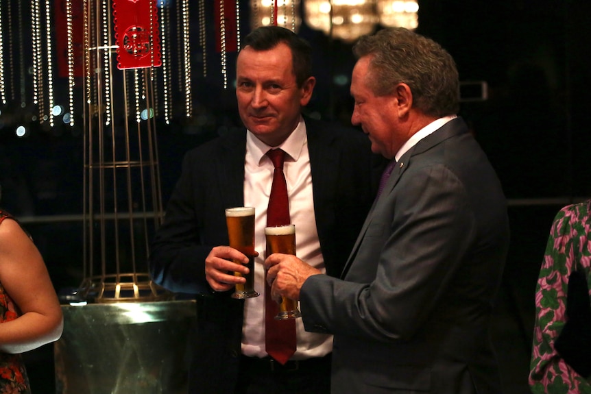 WA Premier Mark McGowan in a suit holding a pint of beer chatting with Andrew Forrest also holding a pint of beer