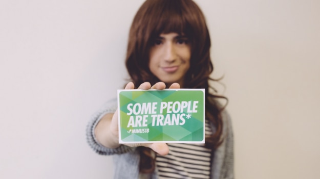 Margot Fink from Minus18 holds a sign that reads, 'Some people are trans'.