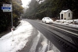 A car makes its way through snow on Mount Wellington, Hobart