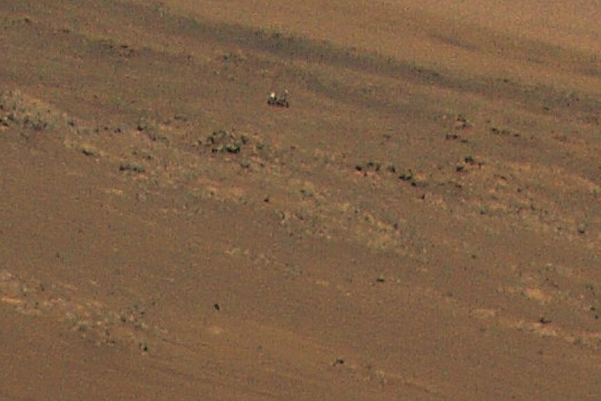 The Perseverance rover in a cropped in photo of a Mars landscape.
