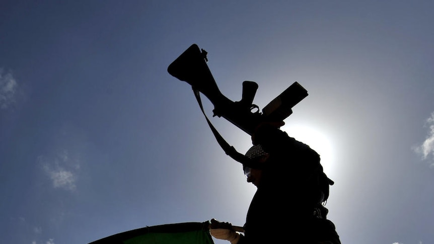 A Libyan anti-Gaddafi fighter waves the flag