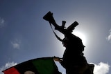 A Libyan anti-Gaddafi fighter waves the flag