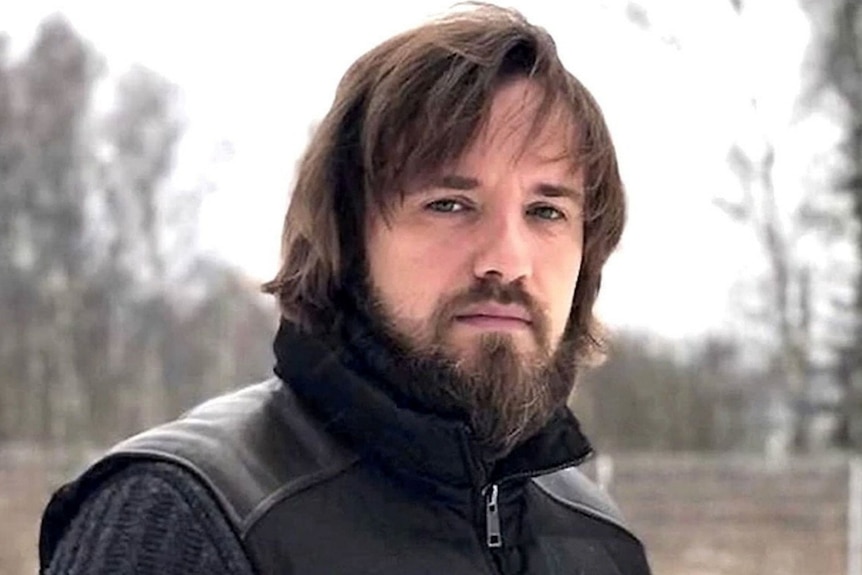 A beared man in a cosy jacket