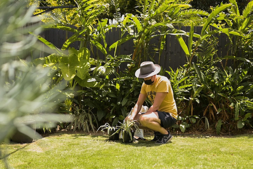Man in the garden with potted plants