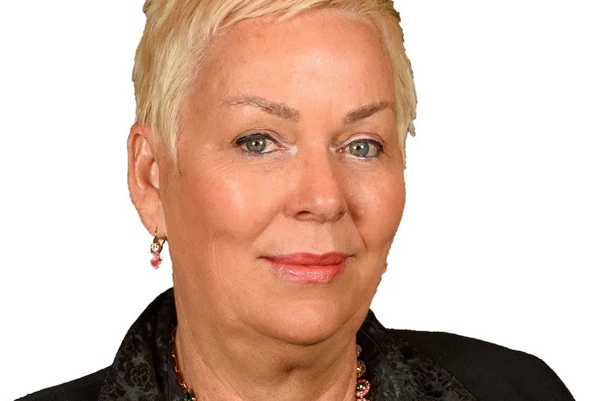 A middle-aged woman with short, blonde hair.