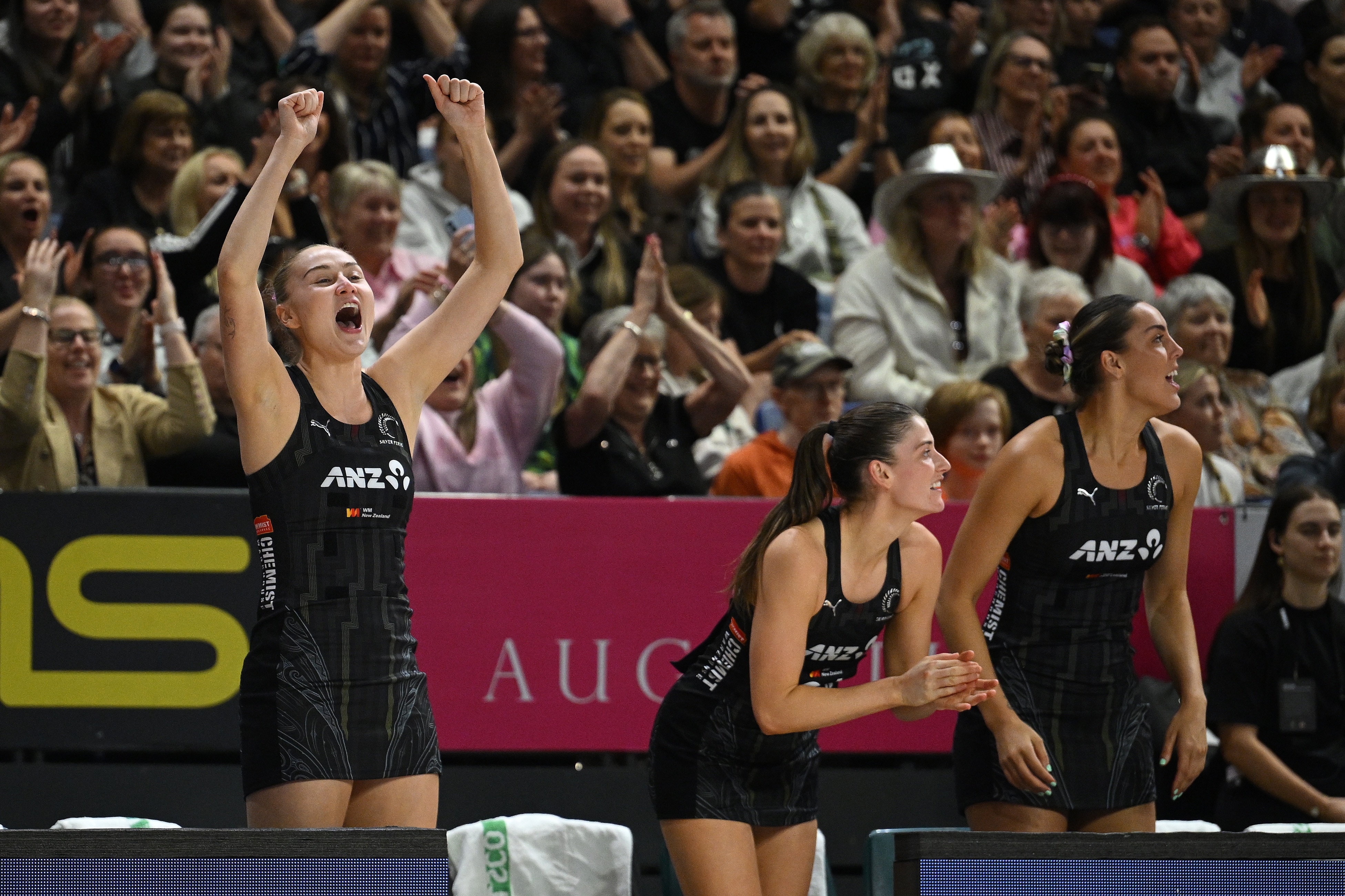 New Zealand Silver Ferns players cheer on the bench during a Constellation Cup game.