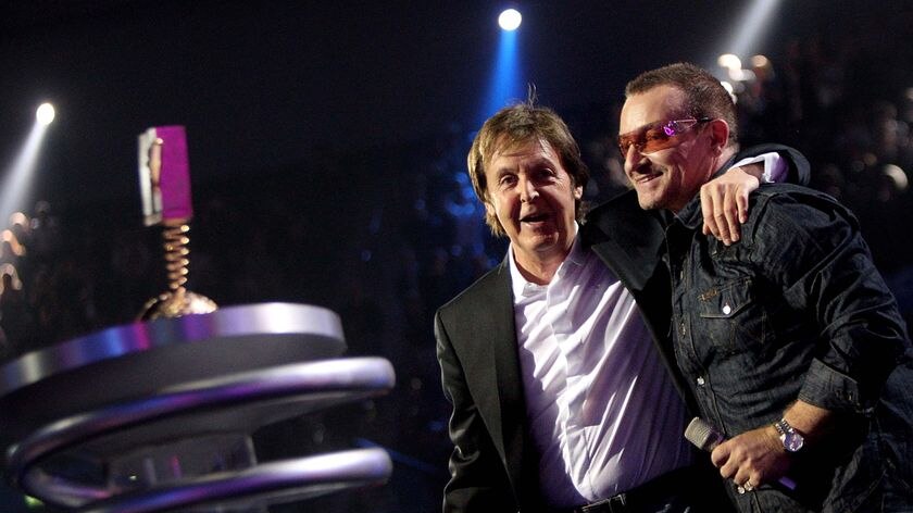 Paul McCartney and Bono embrace onstage at the MTV Europe Music Awards.