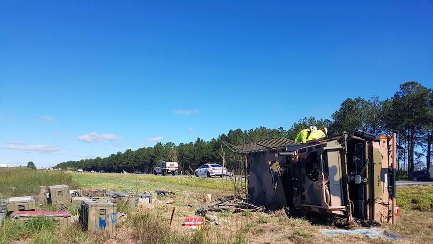 An army truck has rolled off the Bruce Highway, causing traffic congestion to build heading south.