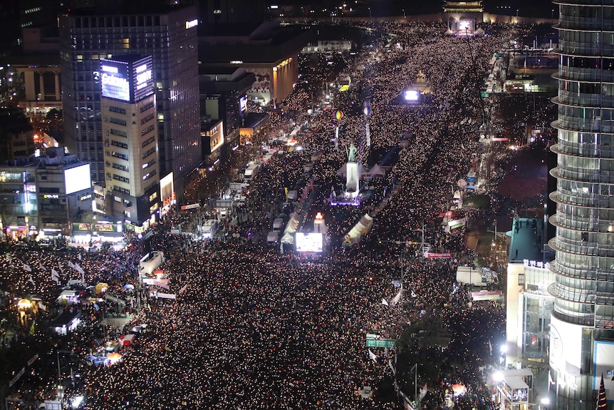 Thousands of people occupy centre of Seoul at night in a protest against Park Geun-hye.