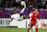 Qatar's Lawrence attempts an overhead kick against China in the 2011 Asian Cup.