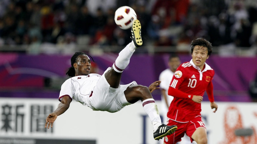 Qatar's Lawrence attempts an overhead kick against China in the 2011 Asian Cup.