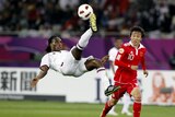 Qatar's Lawrence attempts an overhead kick against China in the 2011 Asian Cup.