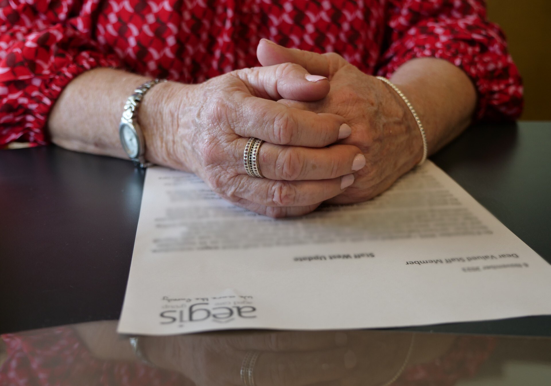 A close up of a woman's hands, clasped to