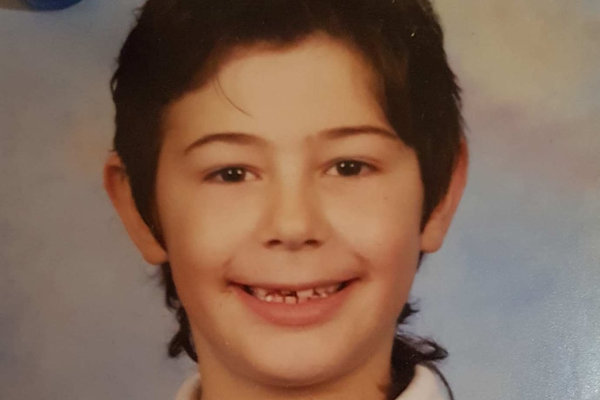 Daniel Pollifrone smiles in a primary school year photo