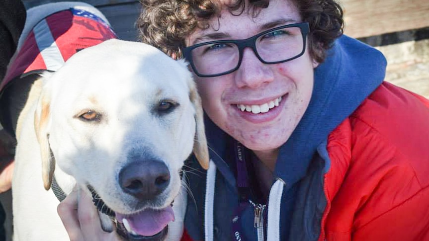 Sam, 18, with his seizure alert dog Chloe who has saved his life on two occasions.