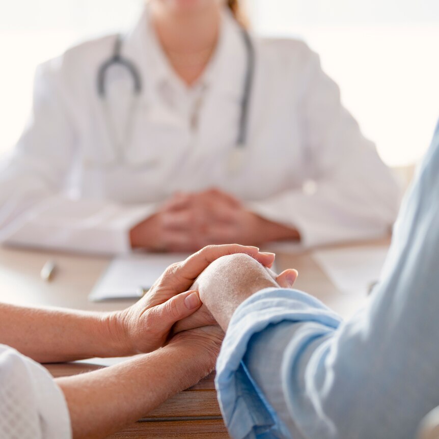 a couple in consultation with medical professional