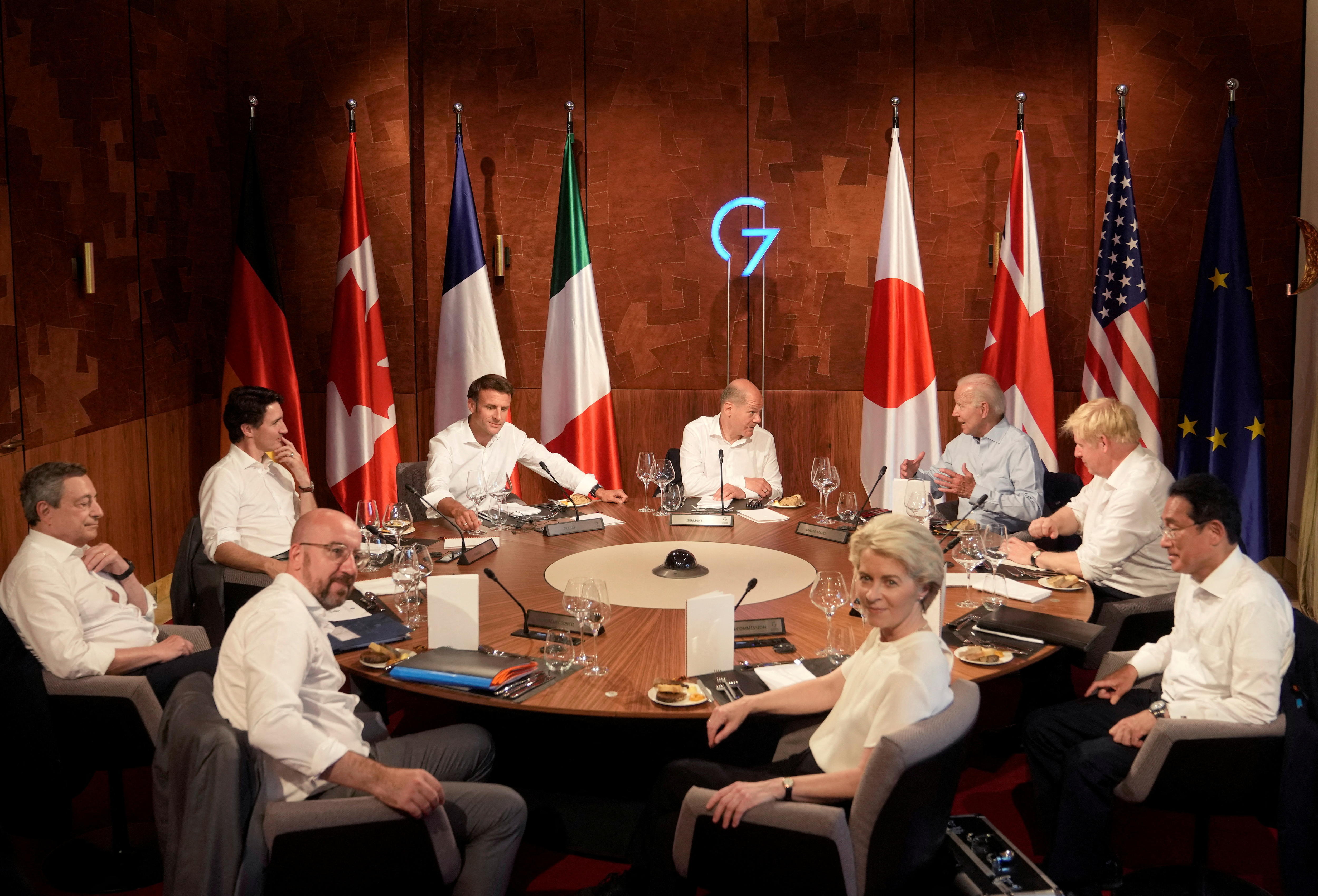 Ursula von der Leyen sits around a table with other world leaders, including Joe Biden and Emmanuel Macron.