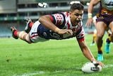 Latrell Mitchell scores a try in the corner against the Broncos