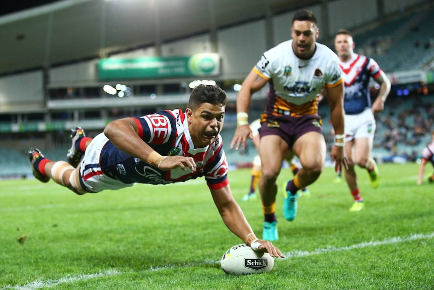 Latrell Mitchell scores a try in the corner against the Broncos