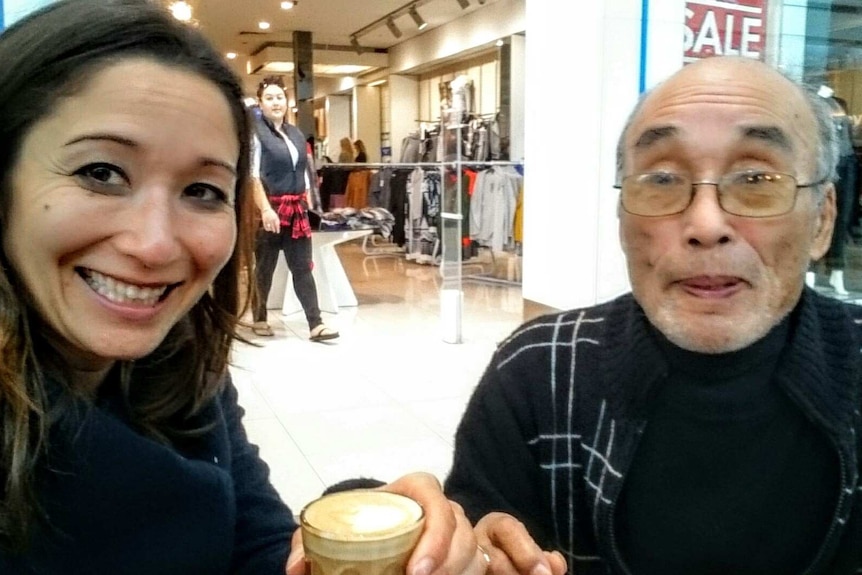 Kumi Taguchi and her elderly father in a shopping centre food court.