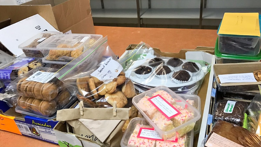 Cakes, biscuits and slices are lined up to be delivered to homes affected in flooding.