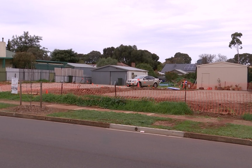 Two vacant house blocks with a shed on each