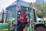 An angry farmer in tractor protesting at Parliament House in Melbourne.