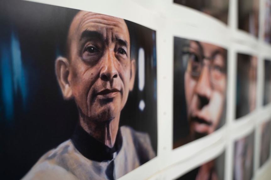 the faces of several men on the portrait wall of a studio