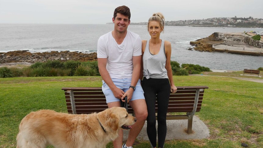 Moises and Krista Henriques with their dog by the beach.