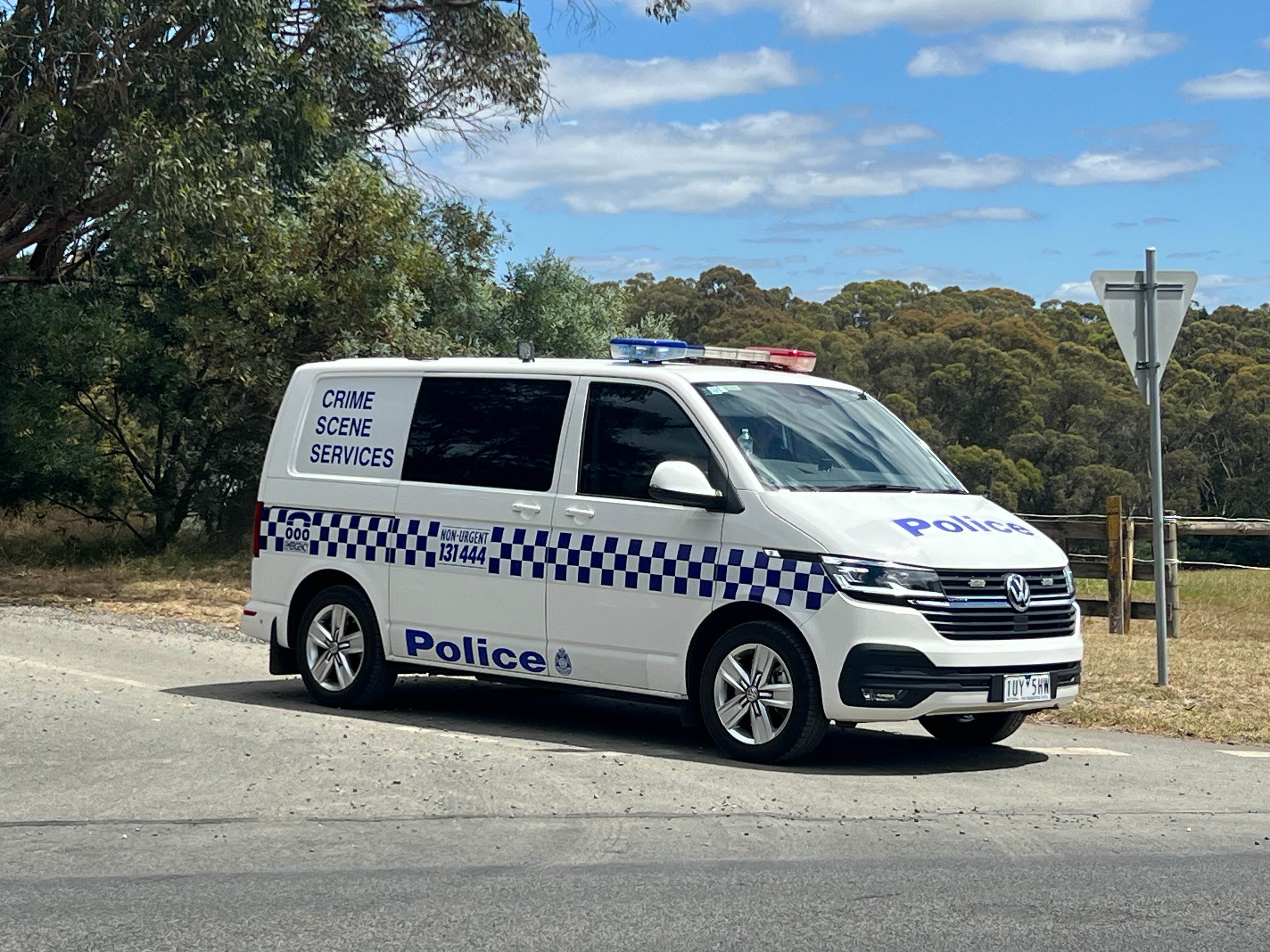 A police crime scene services van at a road intersection