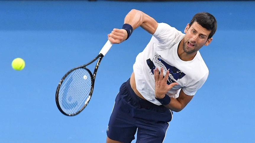 Novak Djokovic hits a serve during practice