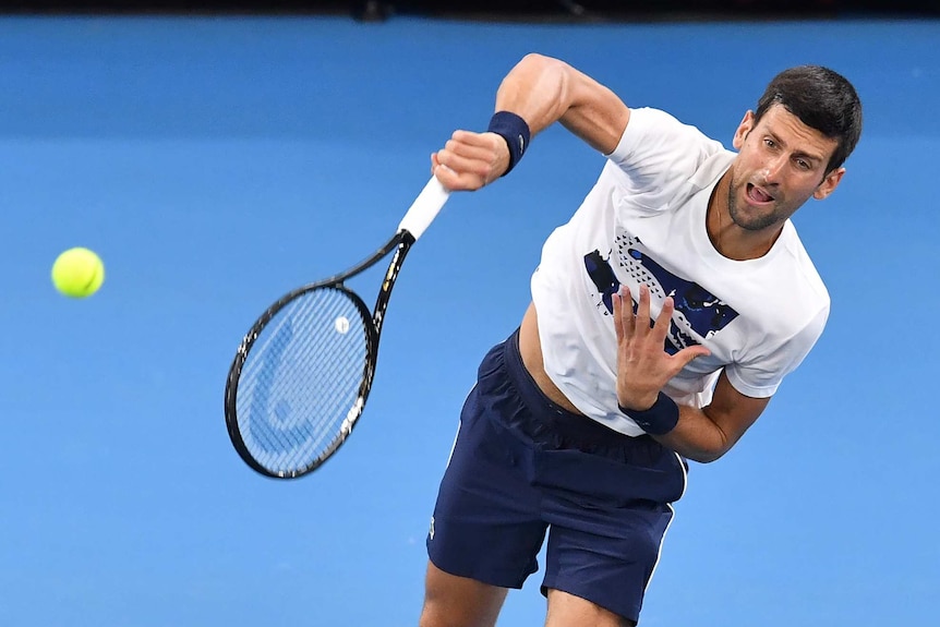 Novak Djokovic hits a serve during practice