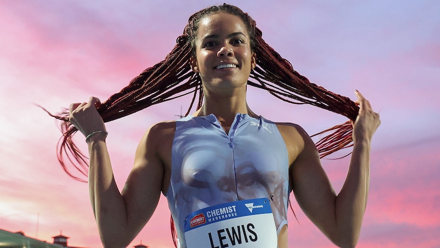 Torrie Lewis holds her hair after competing at the Maurie Plant Meet in Melbourne.