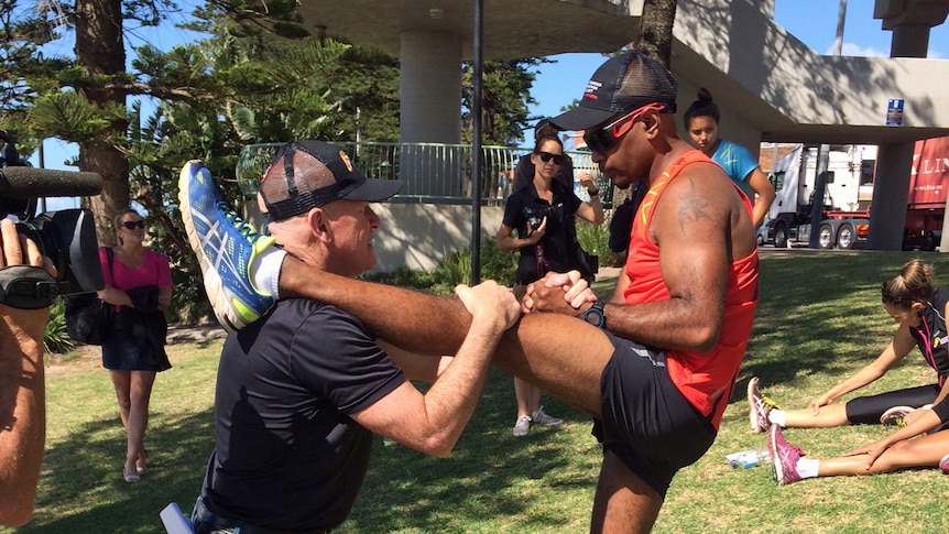 Indigenous runner Adrian Dodson-Shaw stretching in Sydney