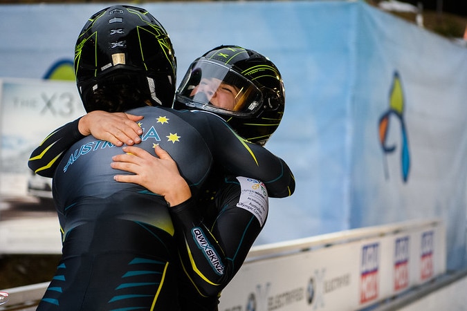 Bree Walker and her teammate hug.