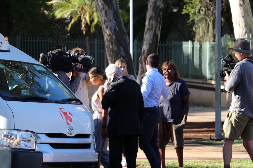 Zachary Rolfe is confronted outside court in Alice Springs as he is surrounded by media before entering a van.