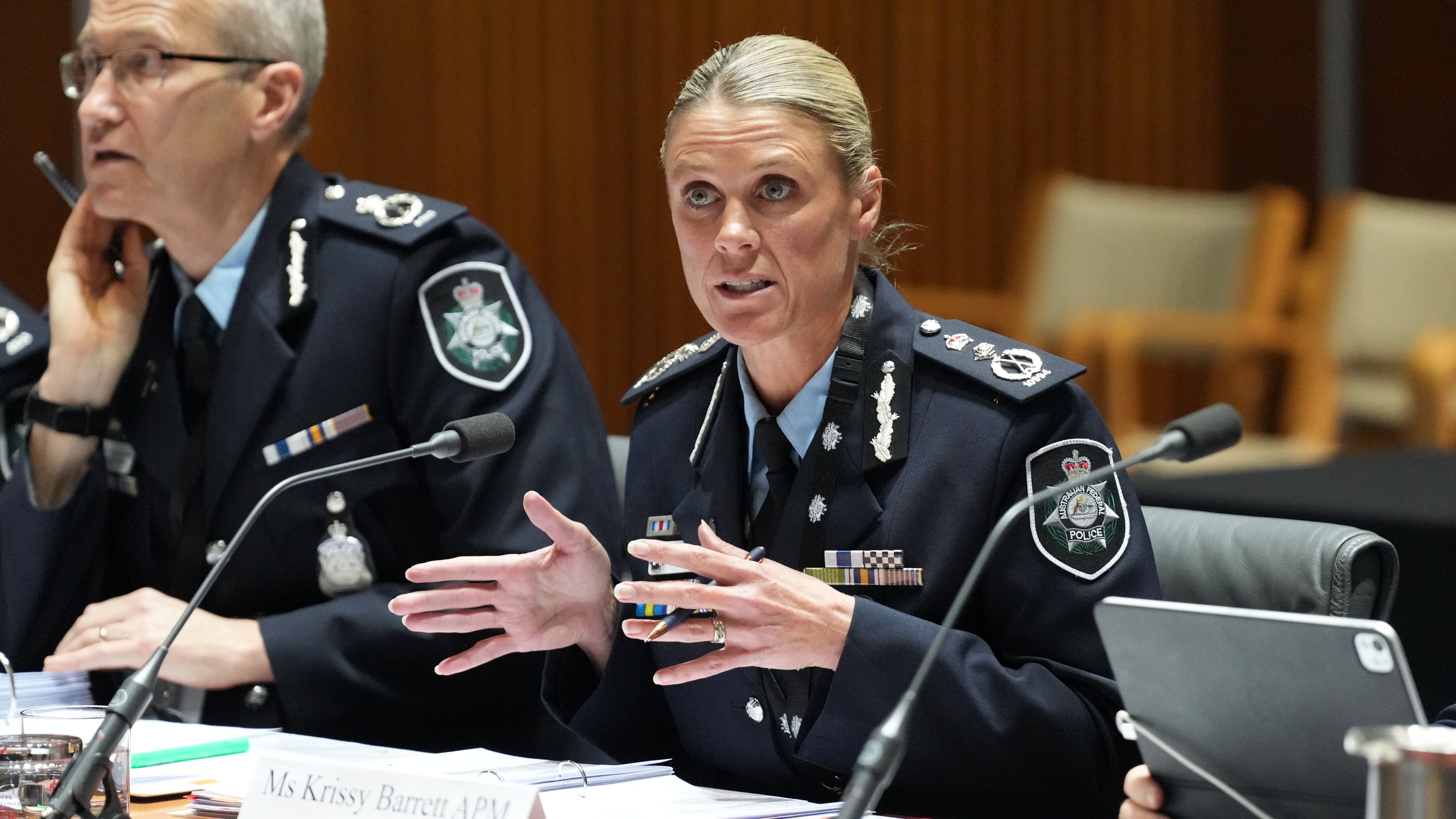 Krissy Barrett in uniform addressing an audience