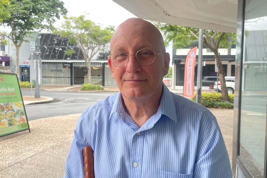 a man with glasses and a blue striped shirt