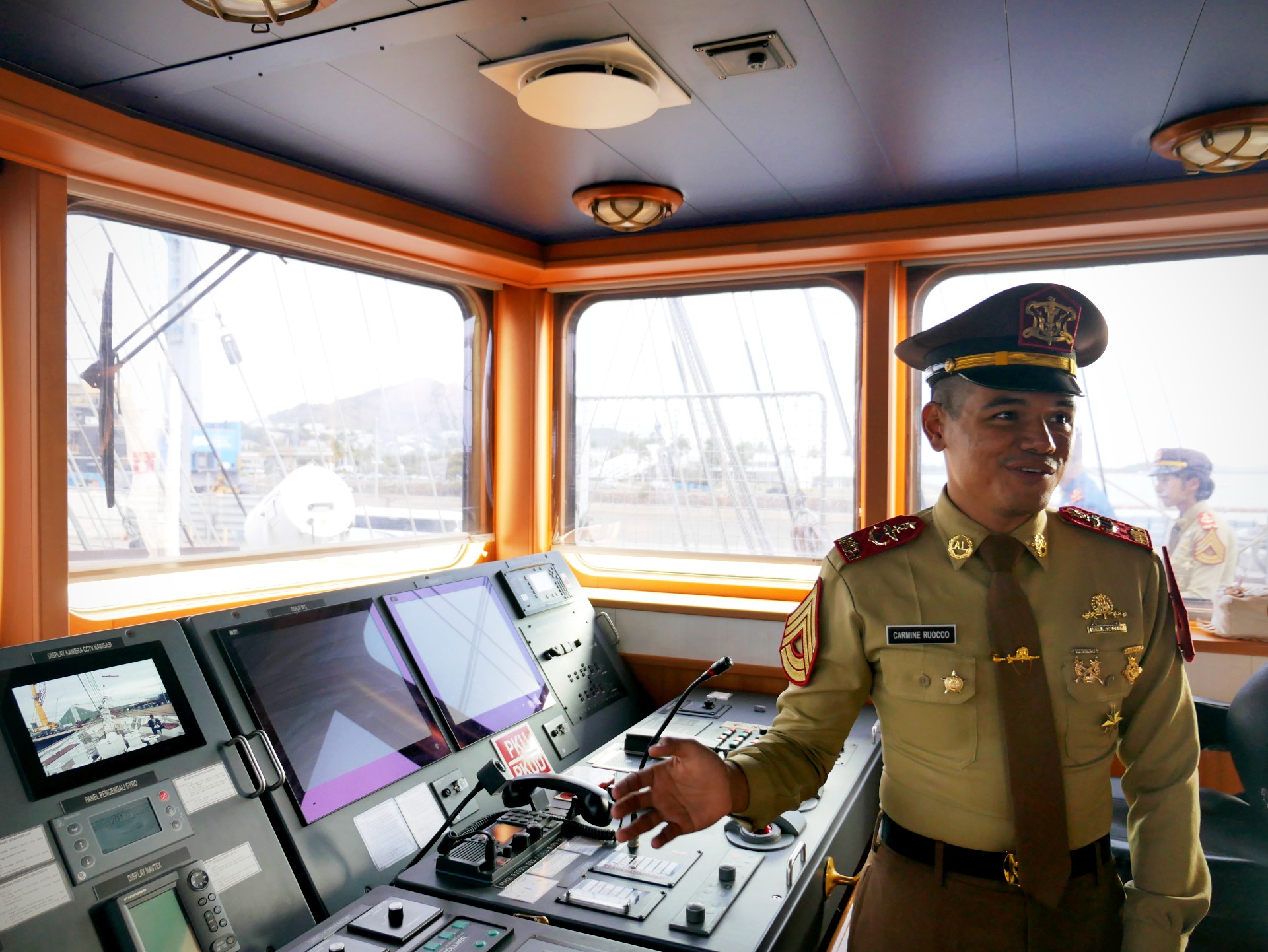 An indonesian navy cadet in the cockpit of an Indonesian navy tall ship