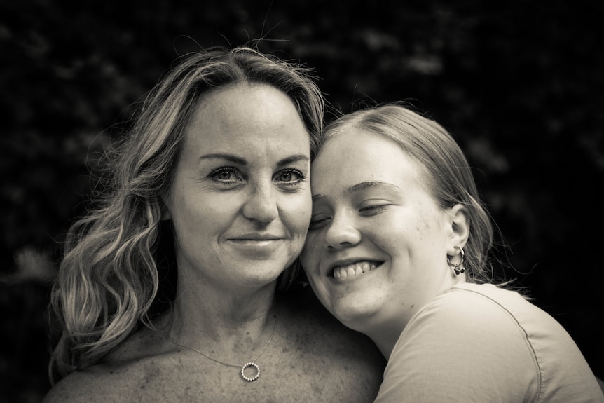 a lady smiling with her daughter 