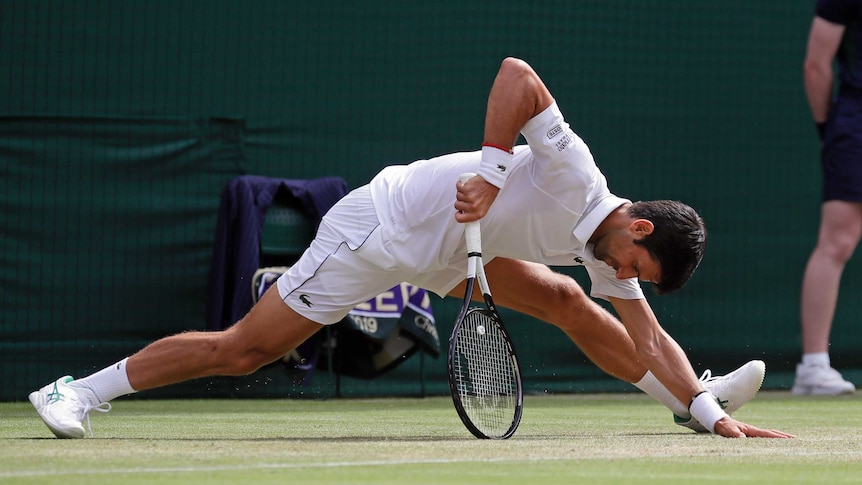 Novak Djokovic almost does the splits but leans on this racquet to stop himself from falling further