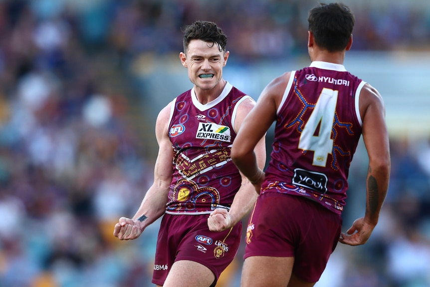 Lachie Neale clenches both fists in celebration