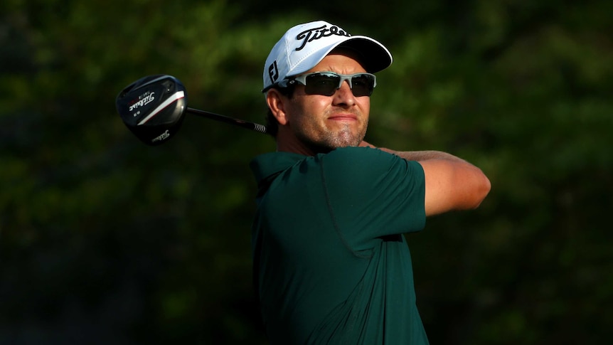 Less than impressed ... Adam Scott hits his tee shot on the 10th hole