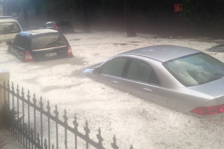 Cars lining the streets in Enmore, Sydney get submerged in storm water.