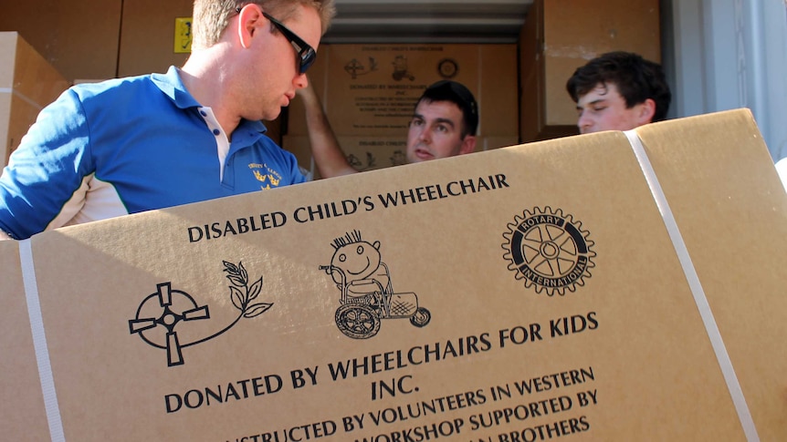 Boxes of children's wheelchairs being loaded into a container by Perth charity Wheelchairs for Kids 14 March 2013